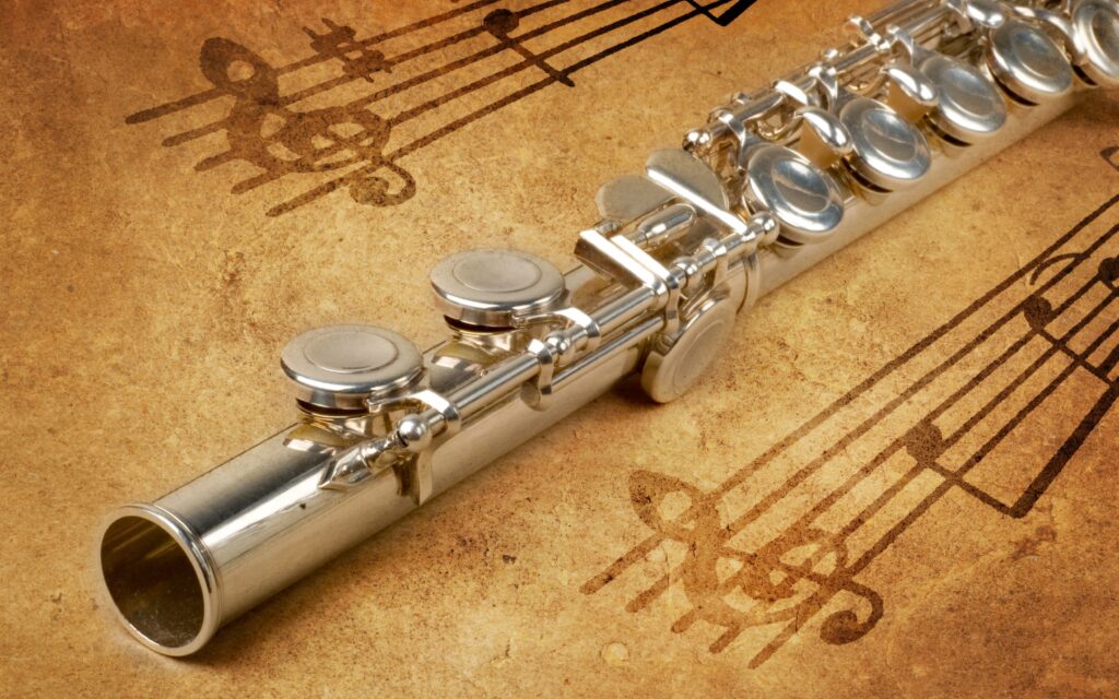 A flute resting on sheet music