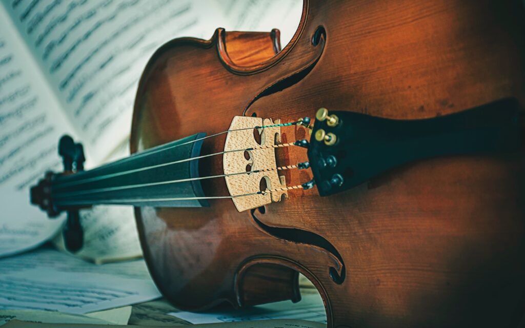 A string instrument resting on sheet music